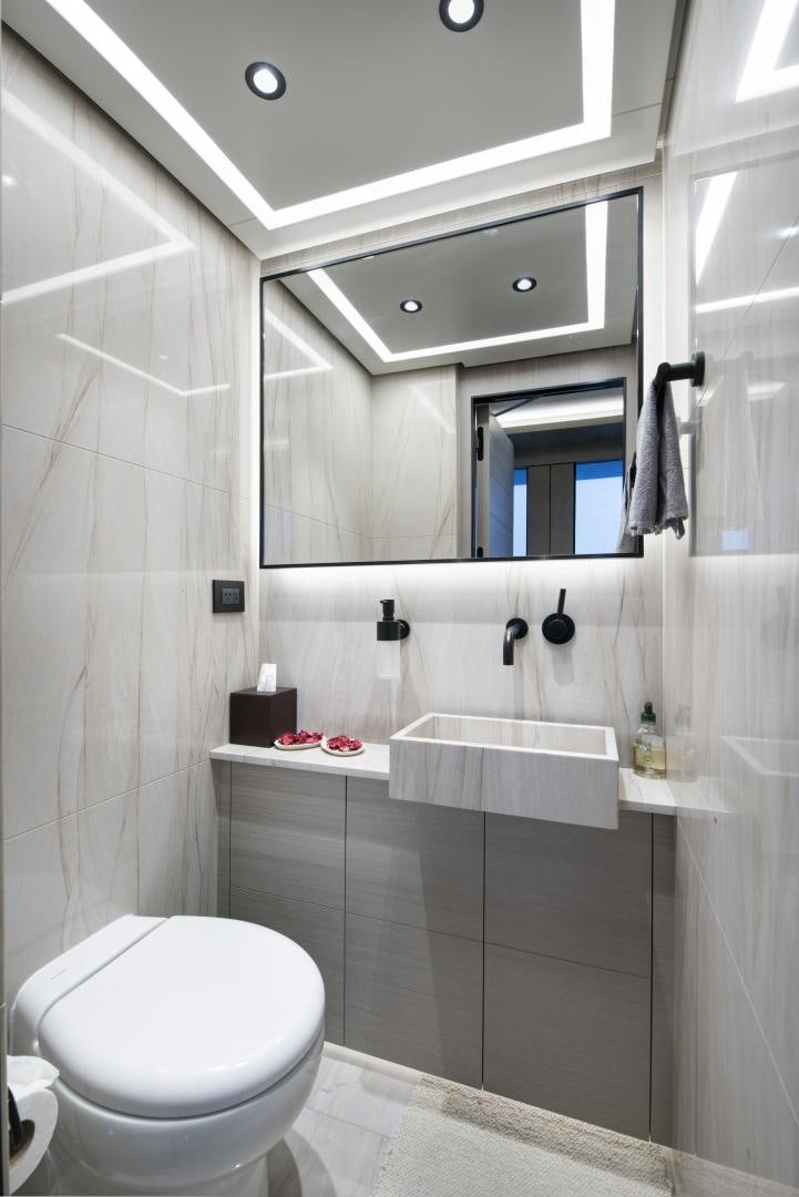 a bathroom with a toilet and a sink aboard ALFRESCO 125 Yacht for Sale