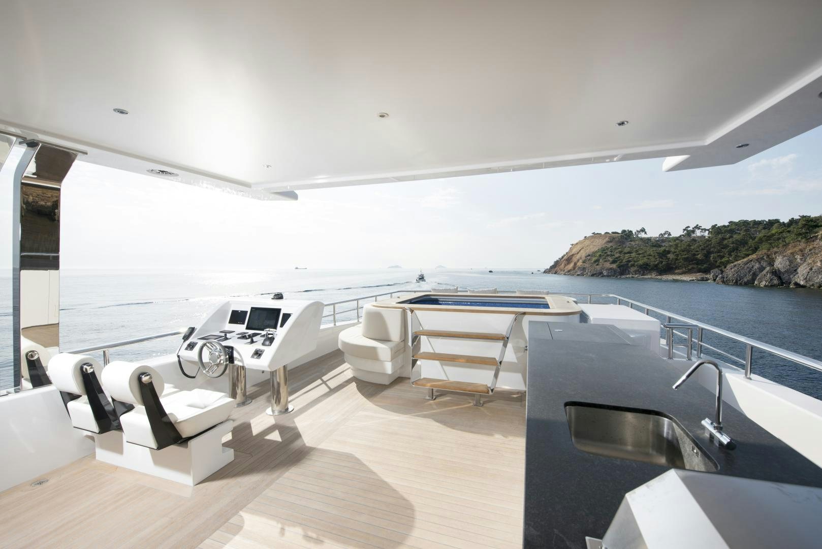 a room with a pool and a table and chairs aboard ALFRESCO 125 Yacht for Sale
