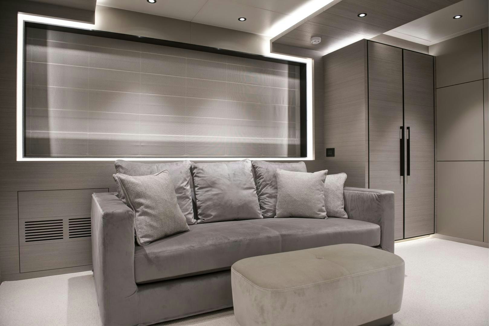 a couch in a room aboard ALFRESCO 125 Yacht for Sale