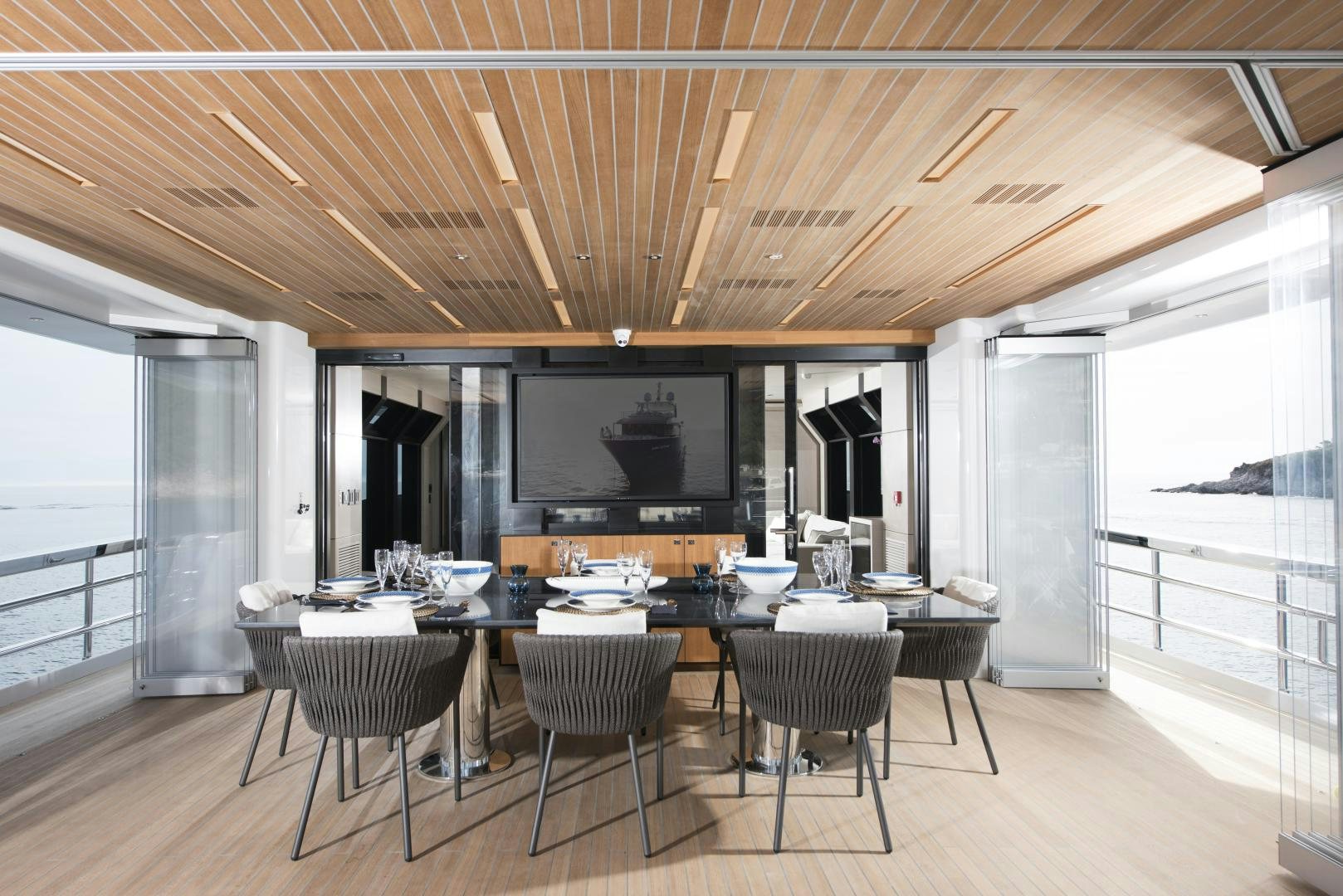 a large kitchen with a large table and chairs aboard ALFRESCO 125 Yacht for Sale