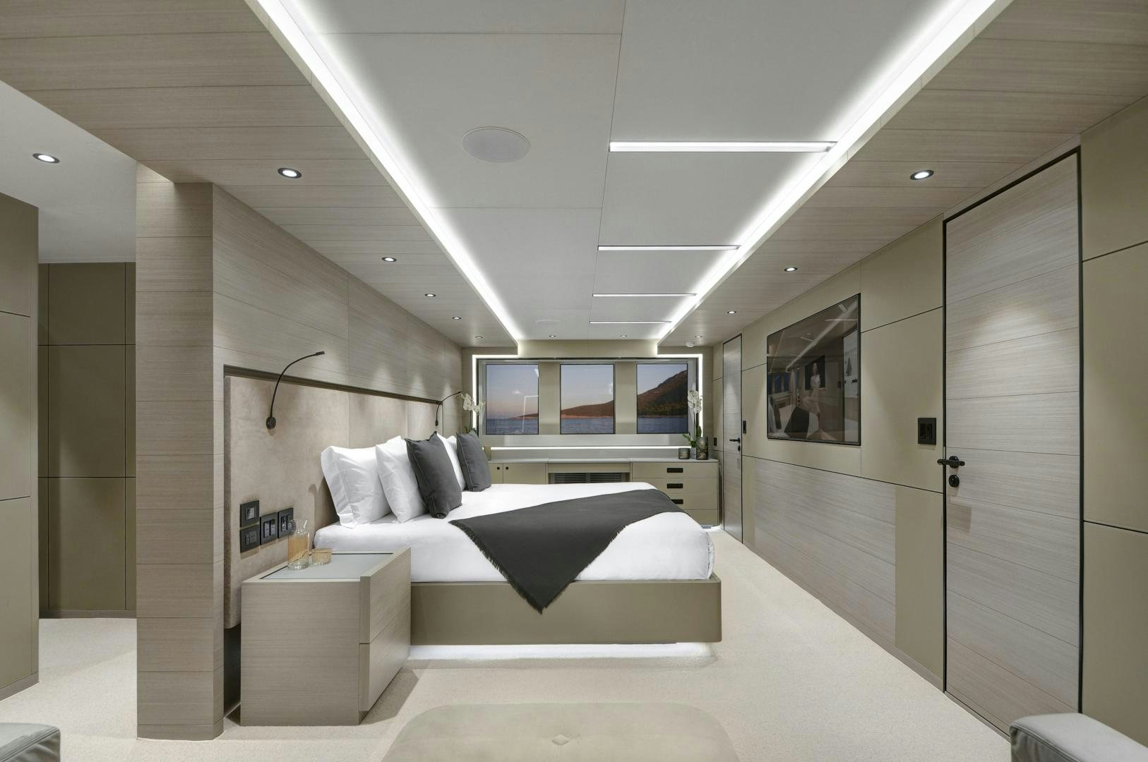 a room with a bed and a desk aboard ALFRESCO 125 Yacht for Sale
