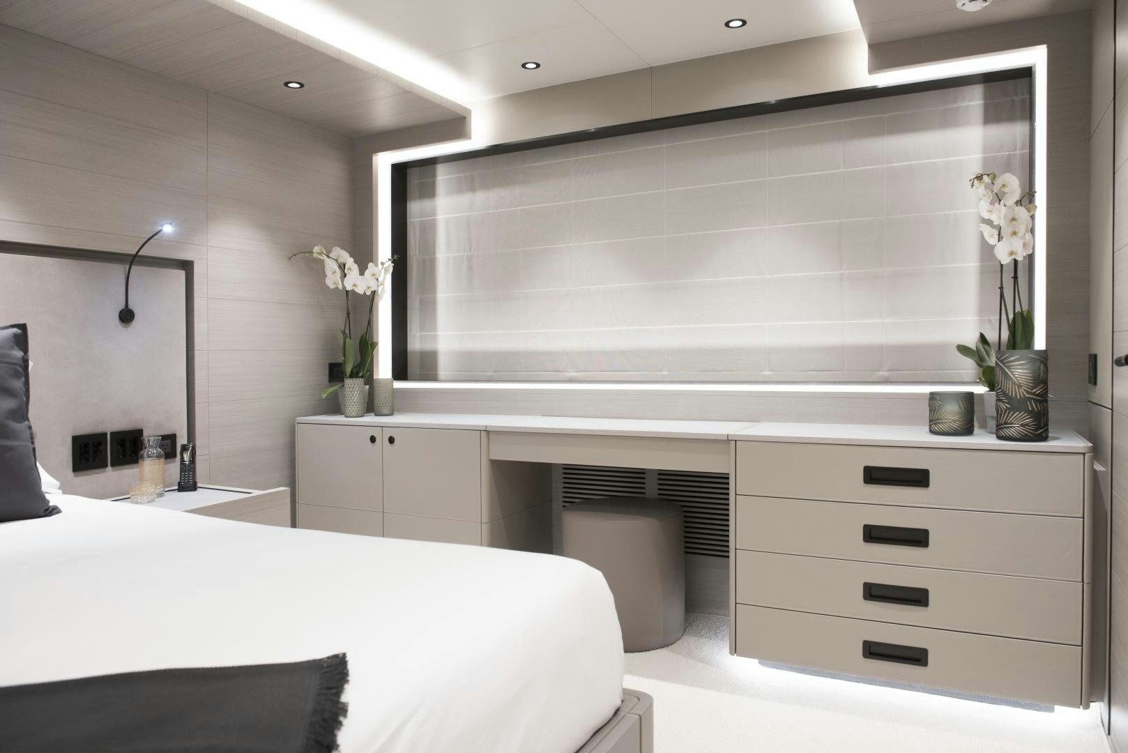 a room with a bed and a desk aboard ALFRESCO 125 Yacht for Sale