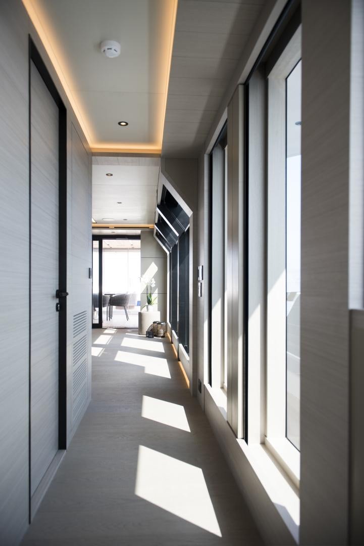 a hallway with white walls aboard ALFRESCO 125 Yacht for Sale