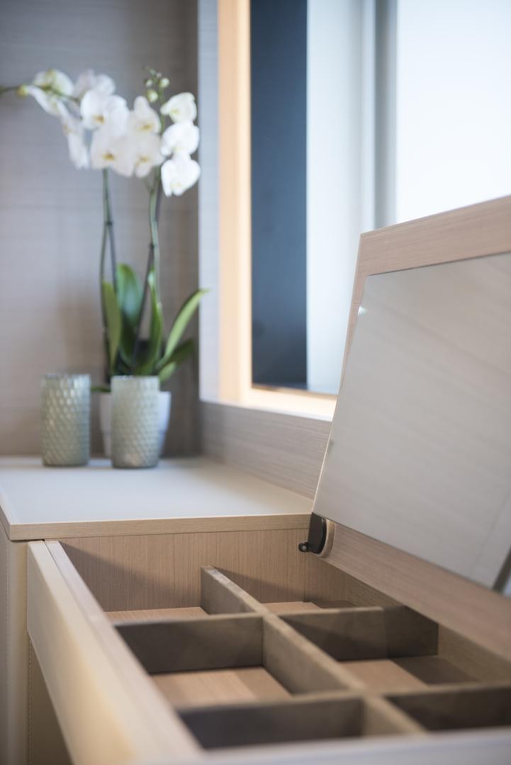 a room with a wood floor and a vase with white flowers aboard ALFRESCO 125 Yacht for Sale