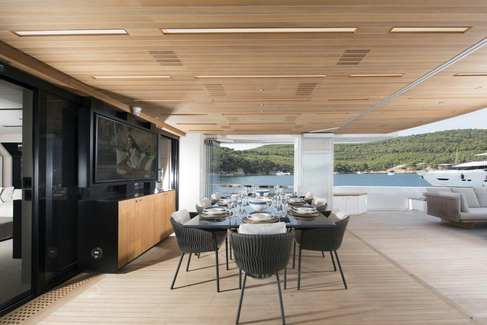 a room with a table and chairs aboard ALFRESCO 125 Yacht for Sale