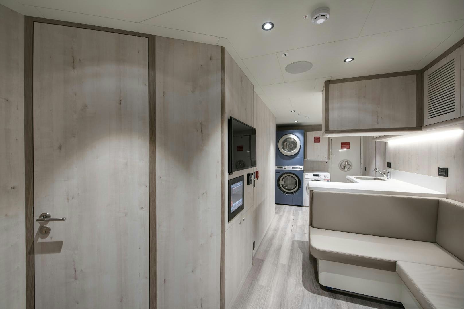 a bathroom with a tub sink and cabinets aboard ALFRESCO 125 Yacht for Sale