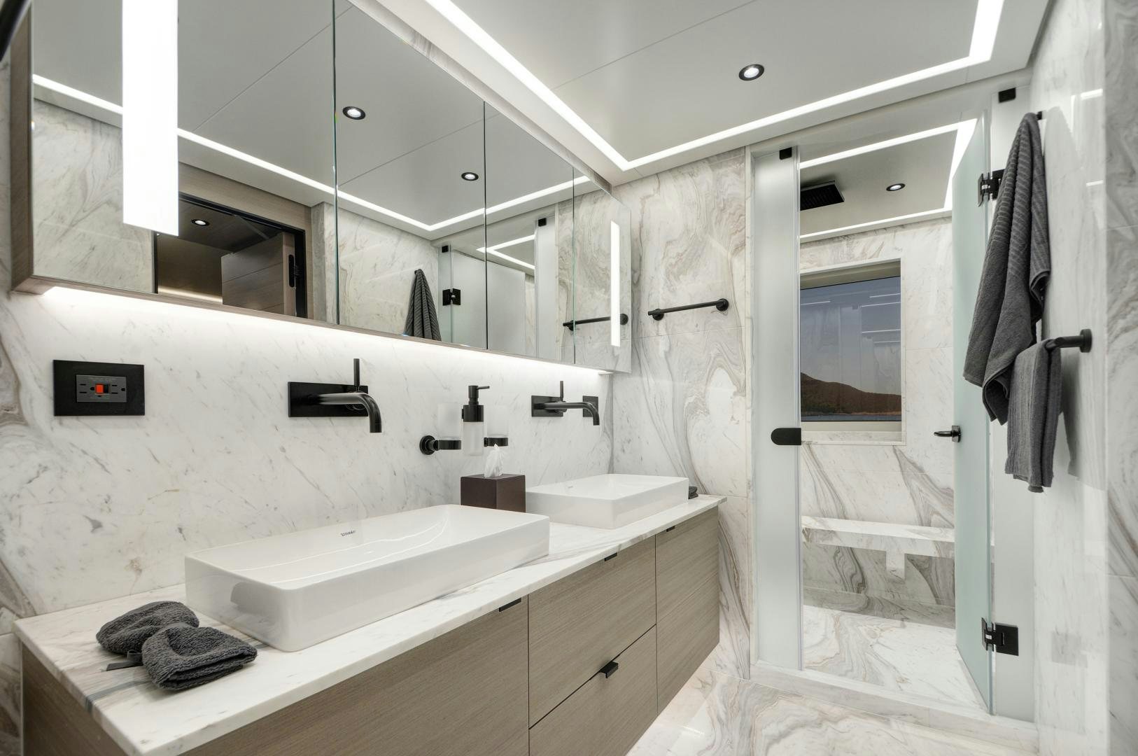 a bathroom with a sink and a mirror aboard ALFRESCO 125 Yacht for Sale