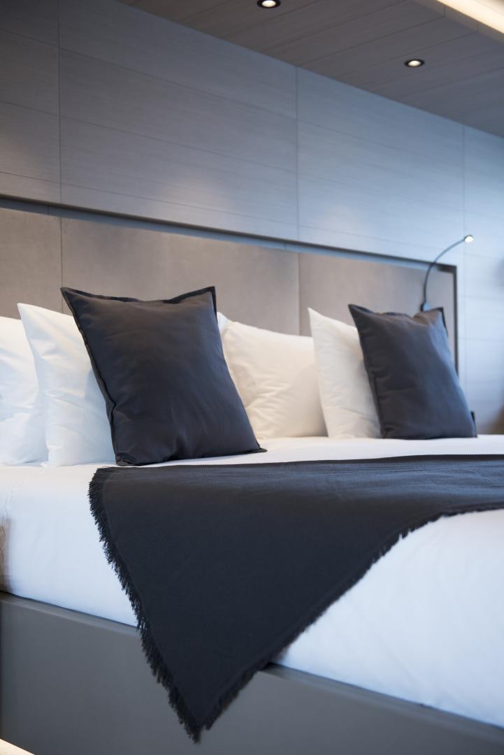 a bed with white sheets aboard ALFRESCO 125 Yacht for Sale