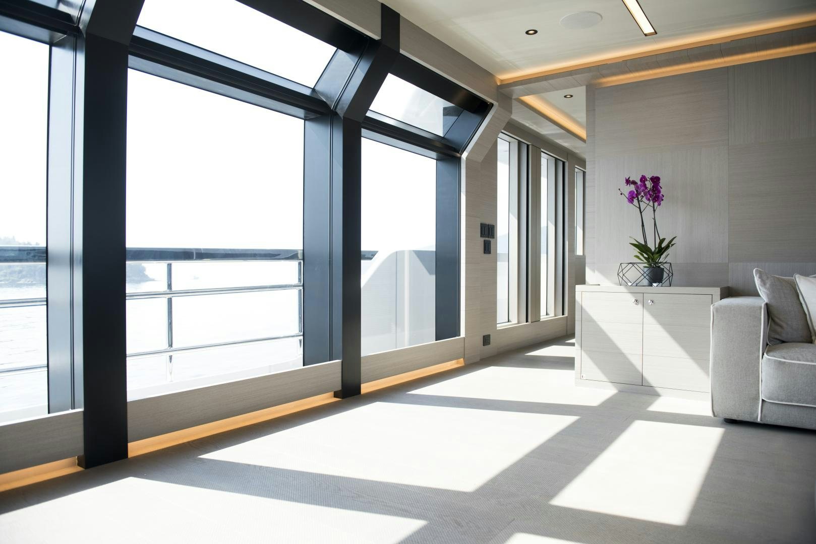 a room with a large window and a white couch aboard ALFRESCO 125 Yacht for Sale