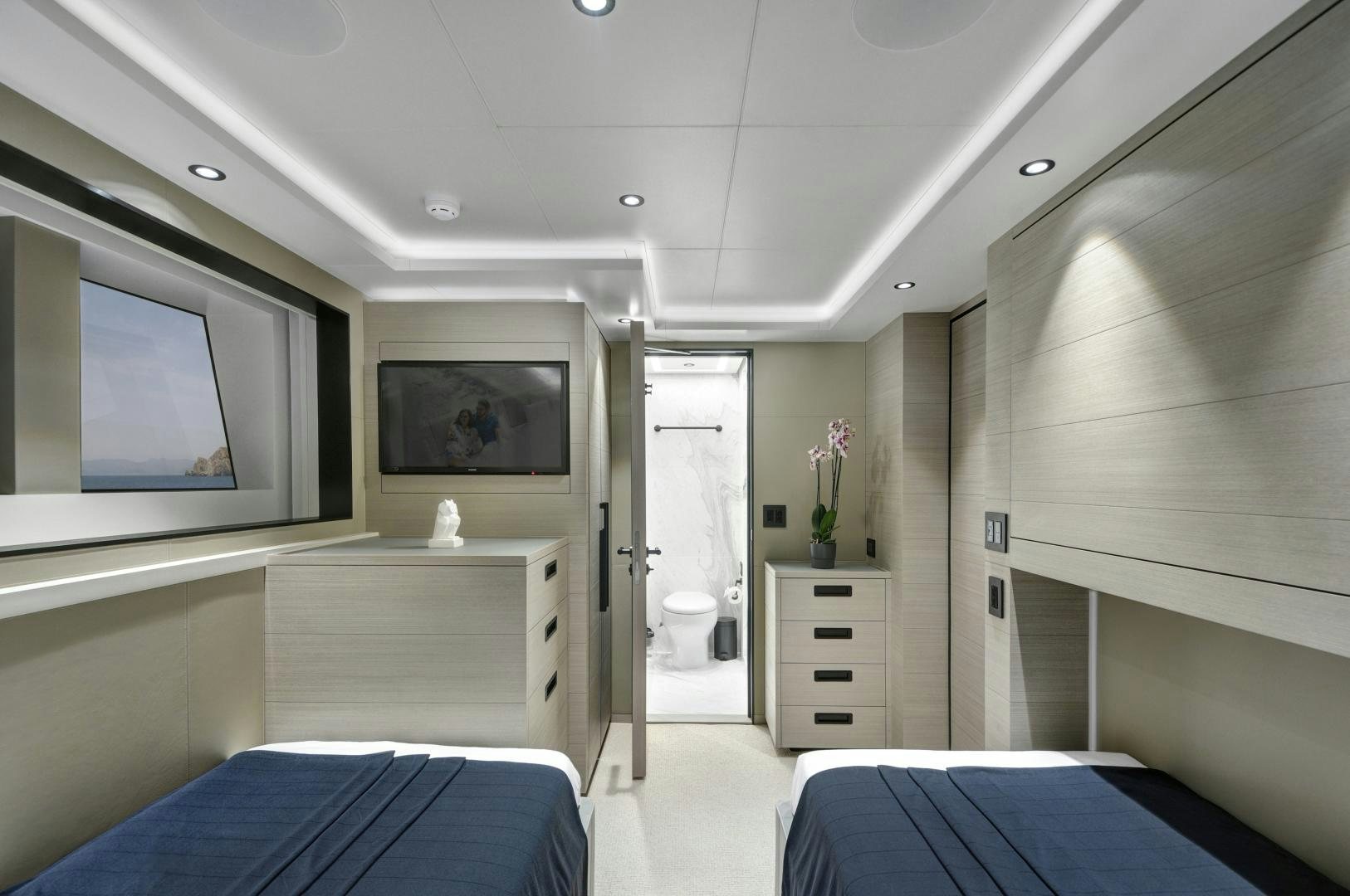 a room with a bed and a desk aboard ALFRESCO 125 Yacht for Sale