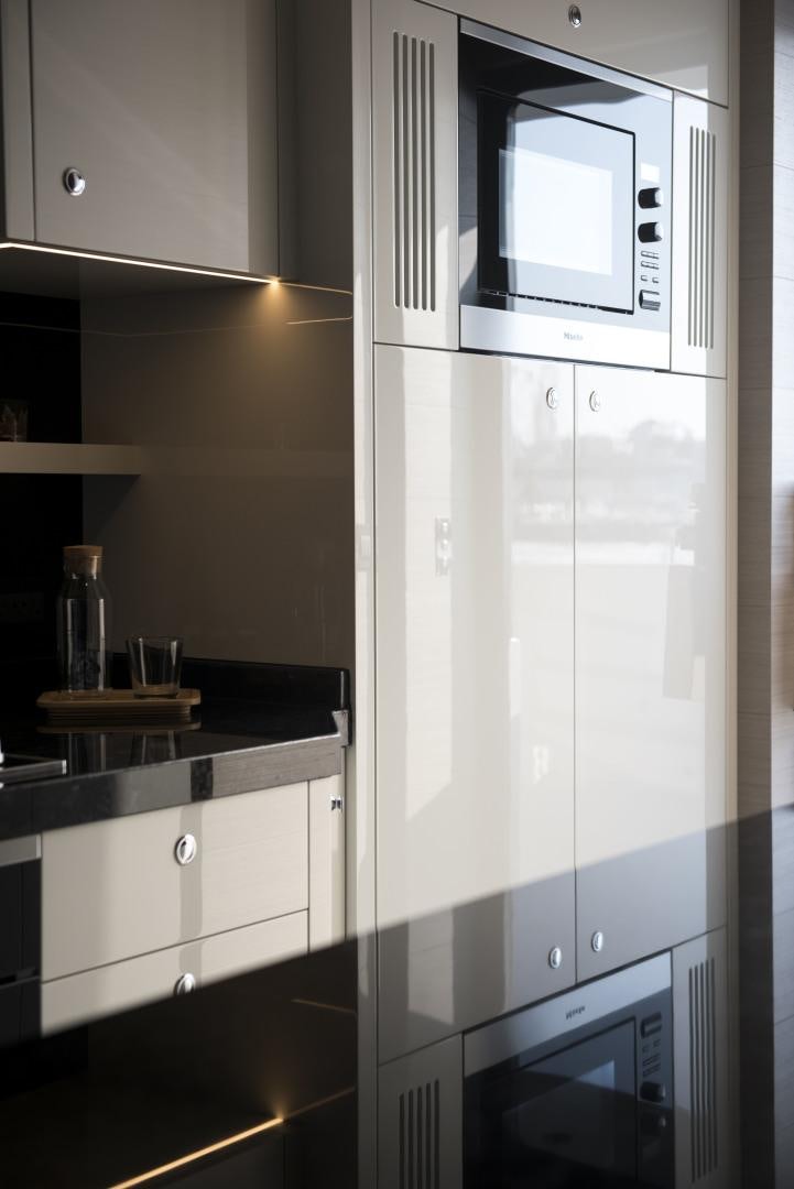 a white refrigerator in a kitchen aboard ALFRESCO 125 Yacht for Sale