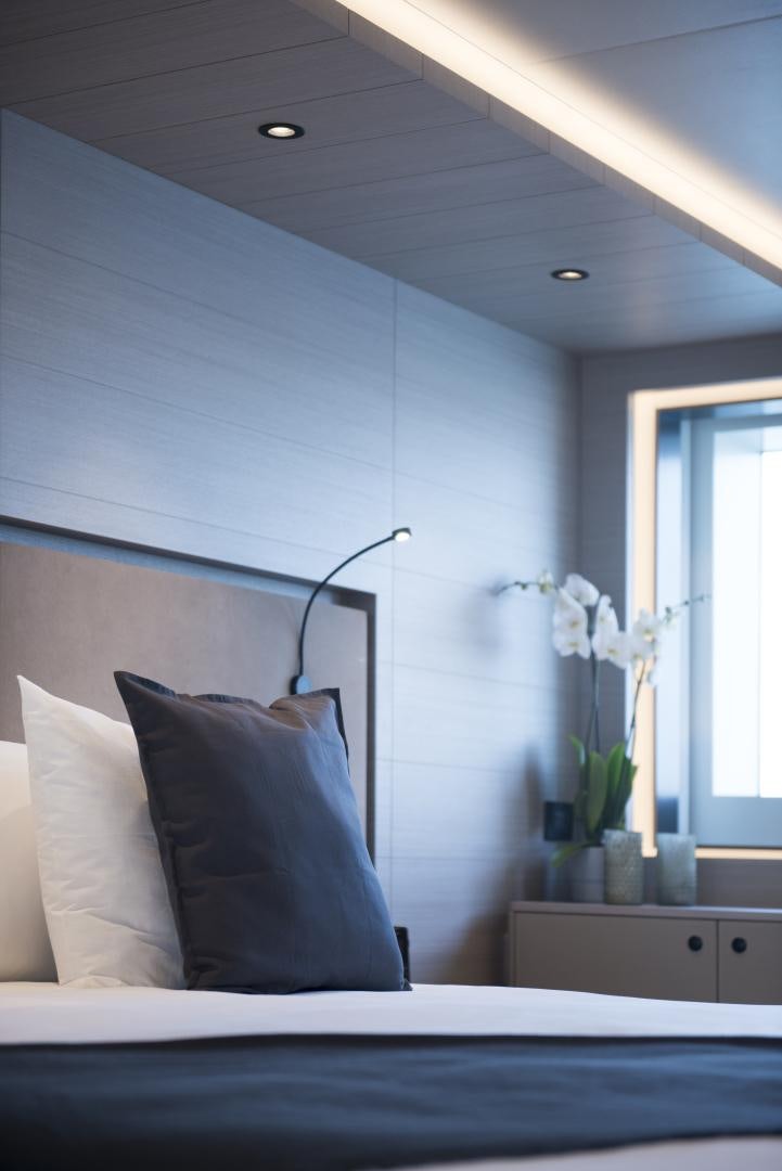 a bed with a blue wall aboard ALFRESCO 125 Yacht for Sale