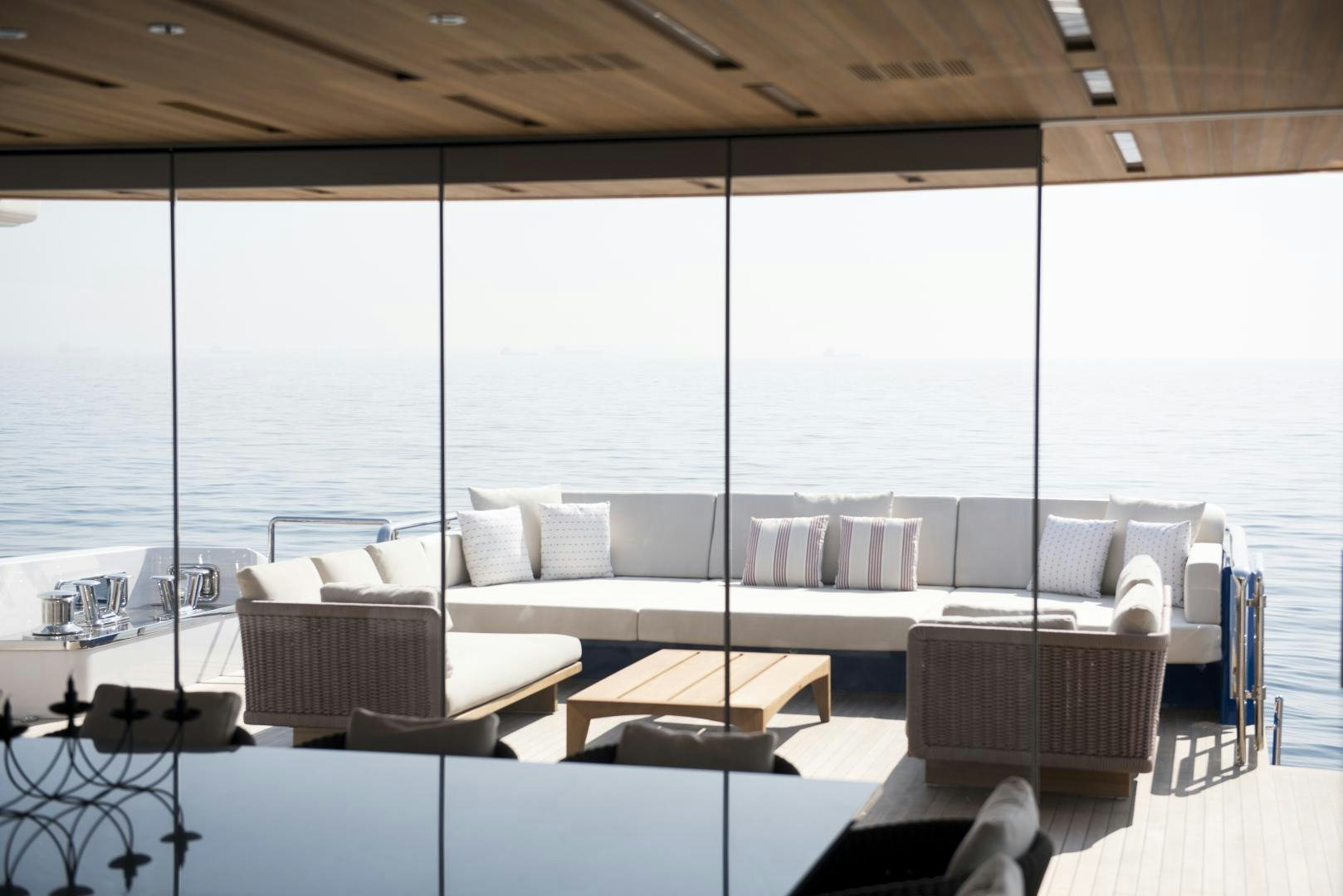 a room with a couch and a table and a large window aboard ALFRESCO 125 Yacht for Sale