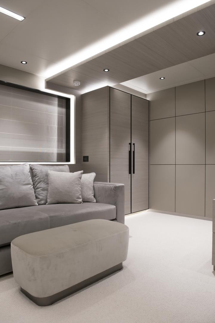 a white couch in a room aboard ALFRESCO 125 Yacht for Sale