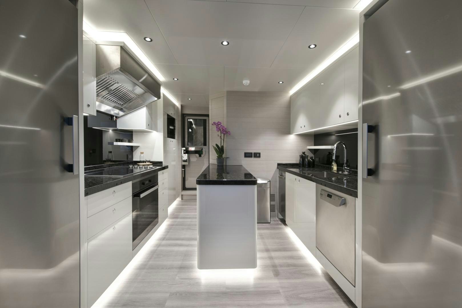 a kitchen with white cabinets aboard ALFRESCO 125 Yacht for Sale