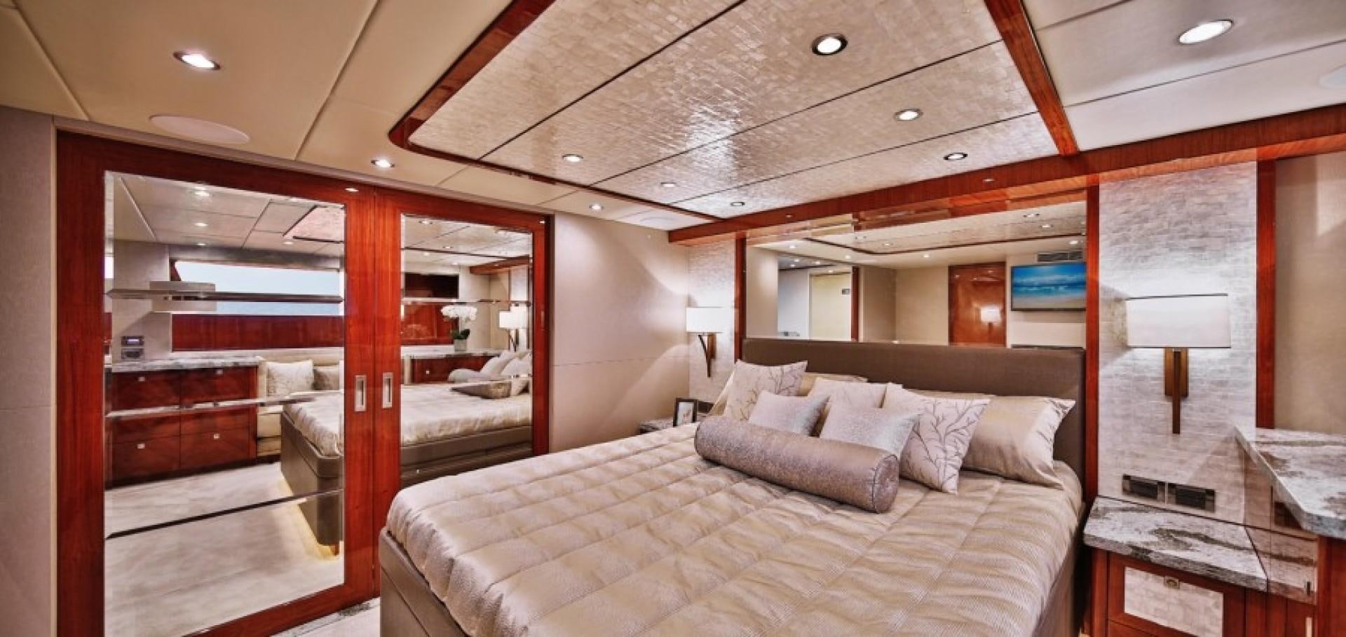 a room with a bed and a desk aboard JOHNSON 80' FLYBRIDGE W/FISHING COCKPIT Yacht for Sale