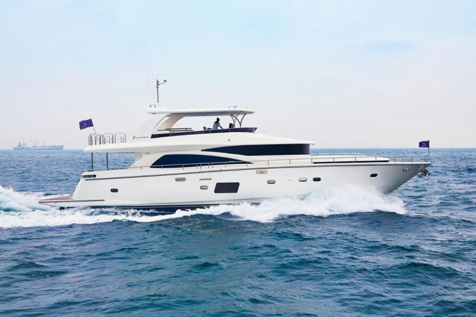 a white yacht on the water aboard JOHNSON 80' FLYBRIDGE W/FISHING COCKPIT Yacht for Sale