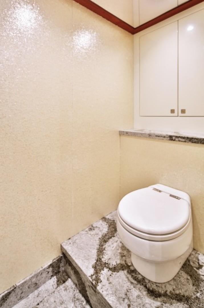 a toilet in a bathroom aboard JOHNSON 80' FLYBRIDGE W/FISHING COCKPIT Yacht for Sale