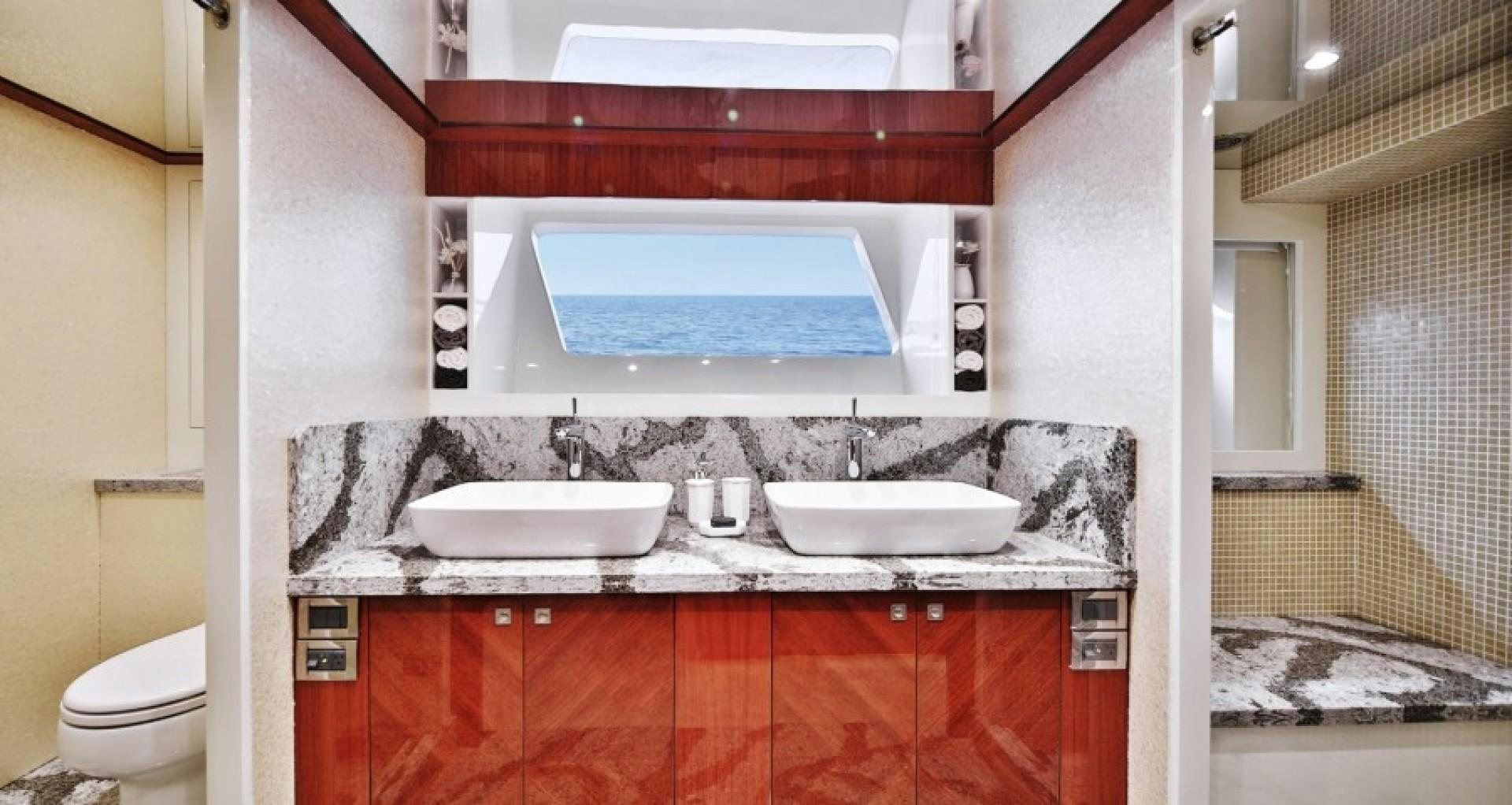 a bathroom with a sink and a mirror aboard JOHNSON 80' FLYBRIDGE W/FISHING COCKPIT Yacht for Sale