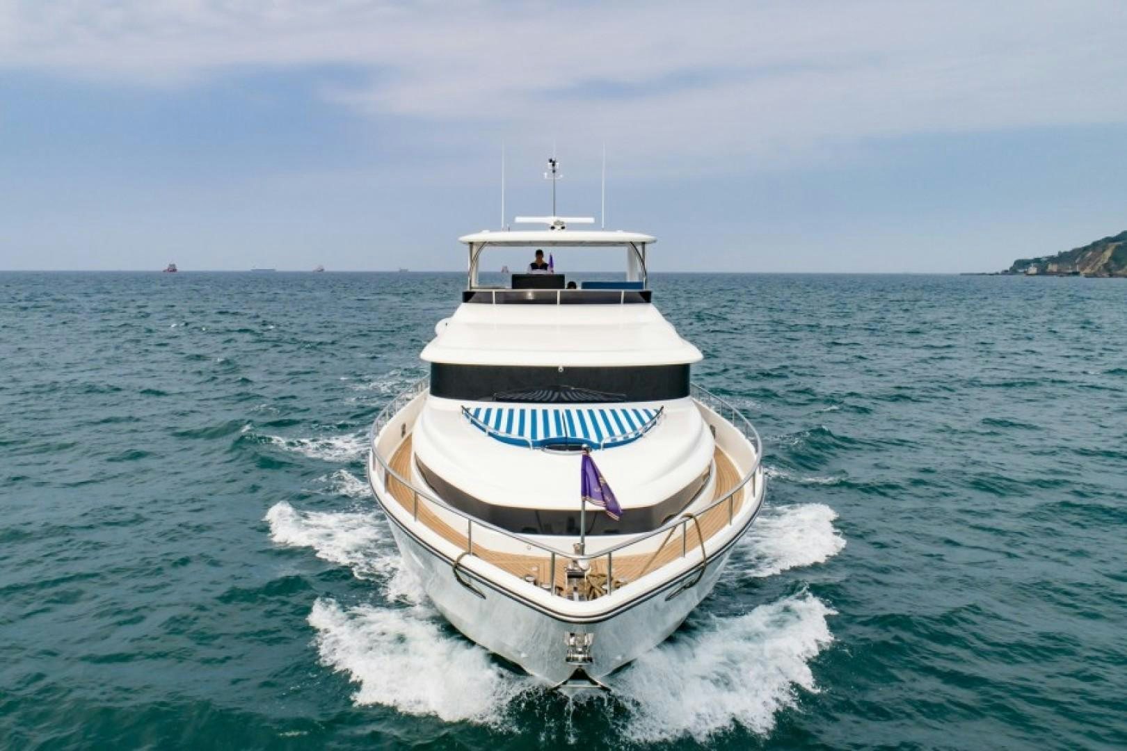 a boat on the water aboard JOHNSON 80' FLYBRIDGE W/FISHING COCKPIT Yacht for Sale