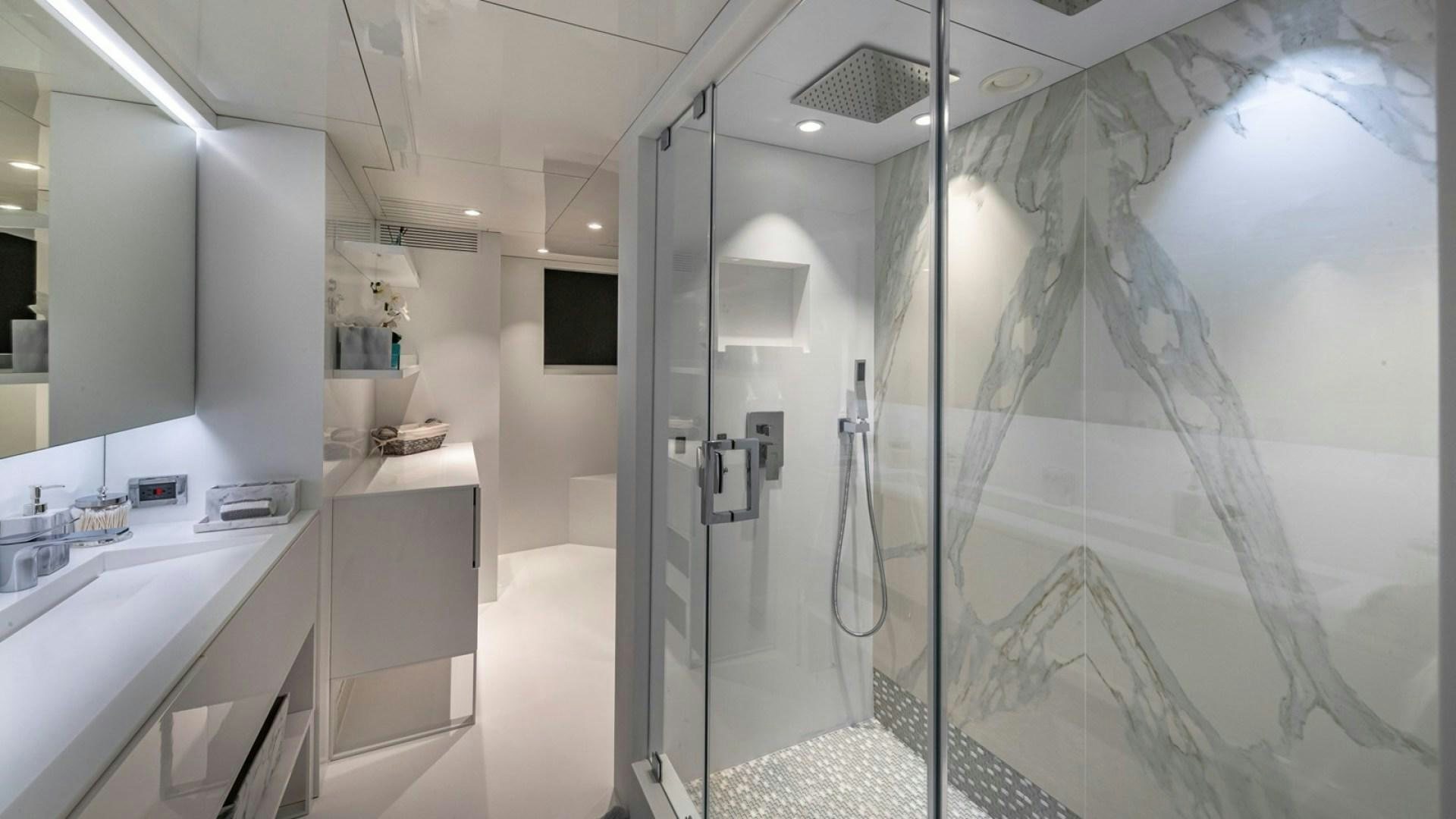 a bathroom with a shower unit and sink aboard OCULUS Yacht for Sale