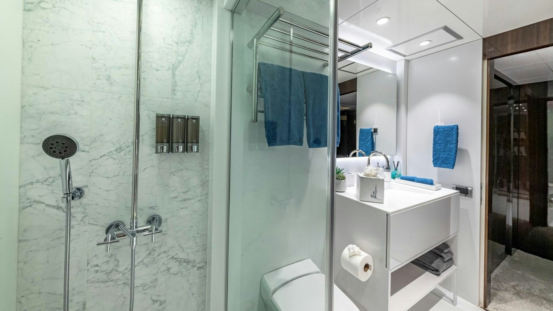 a bathroom with a glass shower aboard OCULUS Yacht for Sale