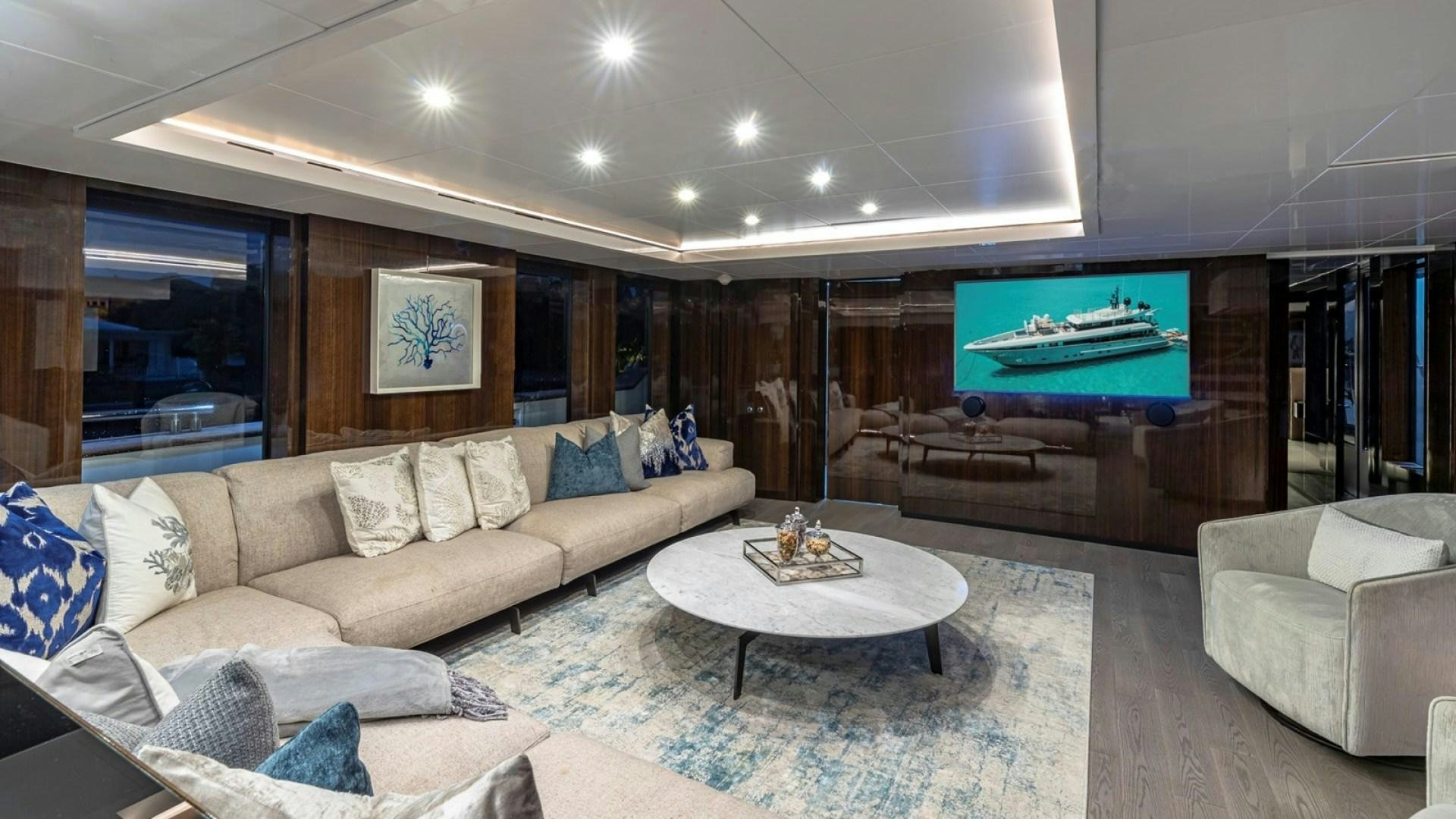 a living room with a large fireplace aboard OCULUS Yacht for Sale