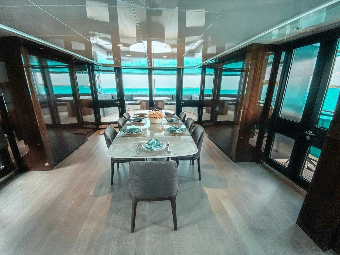 a room with a table and chairs aboard OCULUS Yacht for Sale