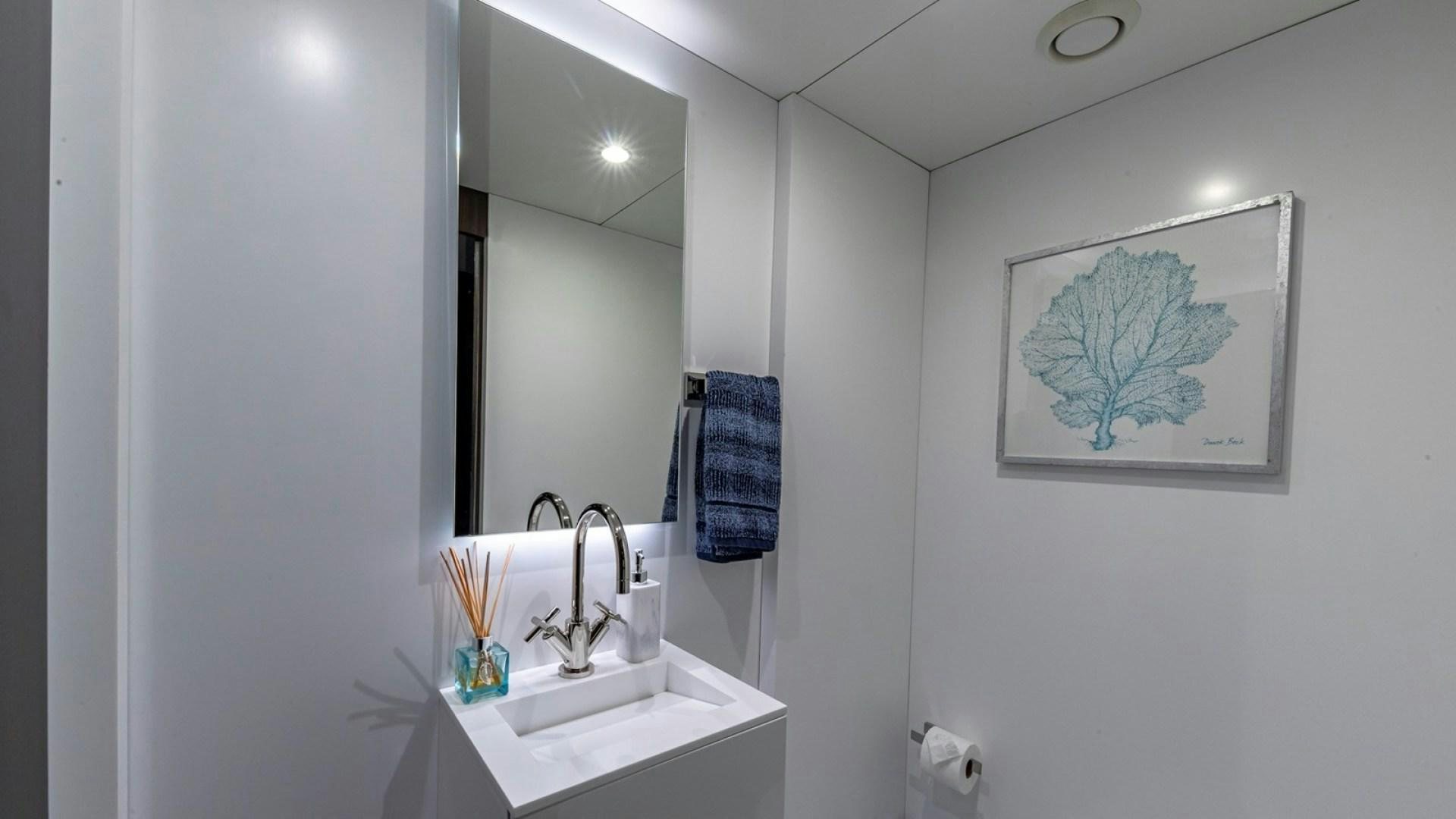 a bathroom with a sink and mirror aboard OCULUS Yacht for Sale