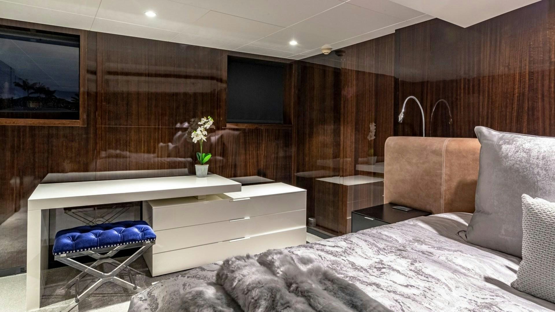 a room with a bed and a television aboard OCULUS Yacht for Sale