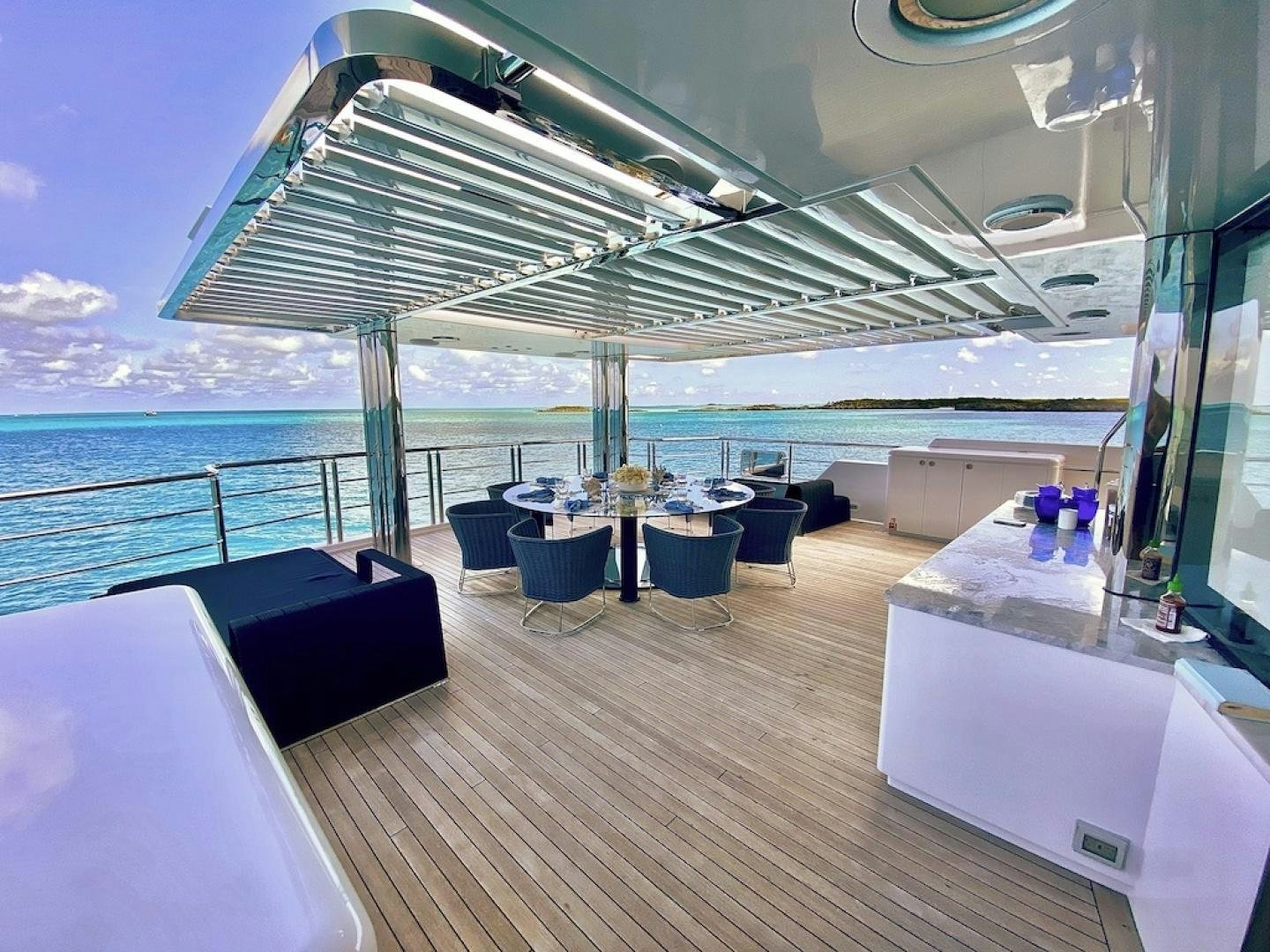 a deck with a view of the ocean and a large city aboard OCULUS Yacht for Sale