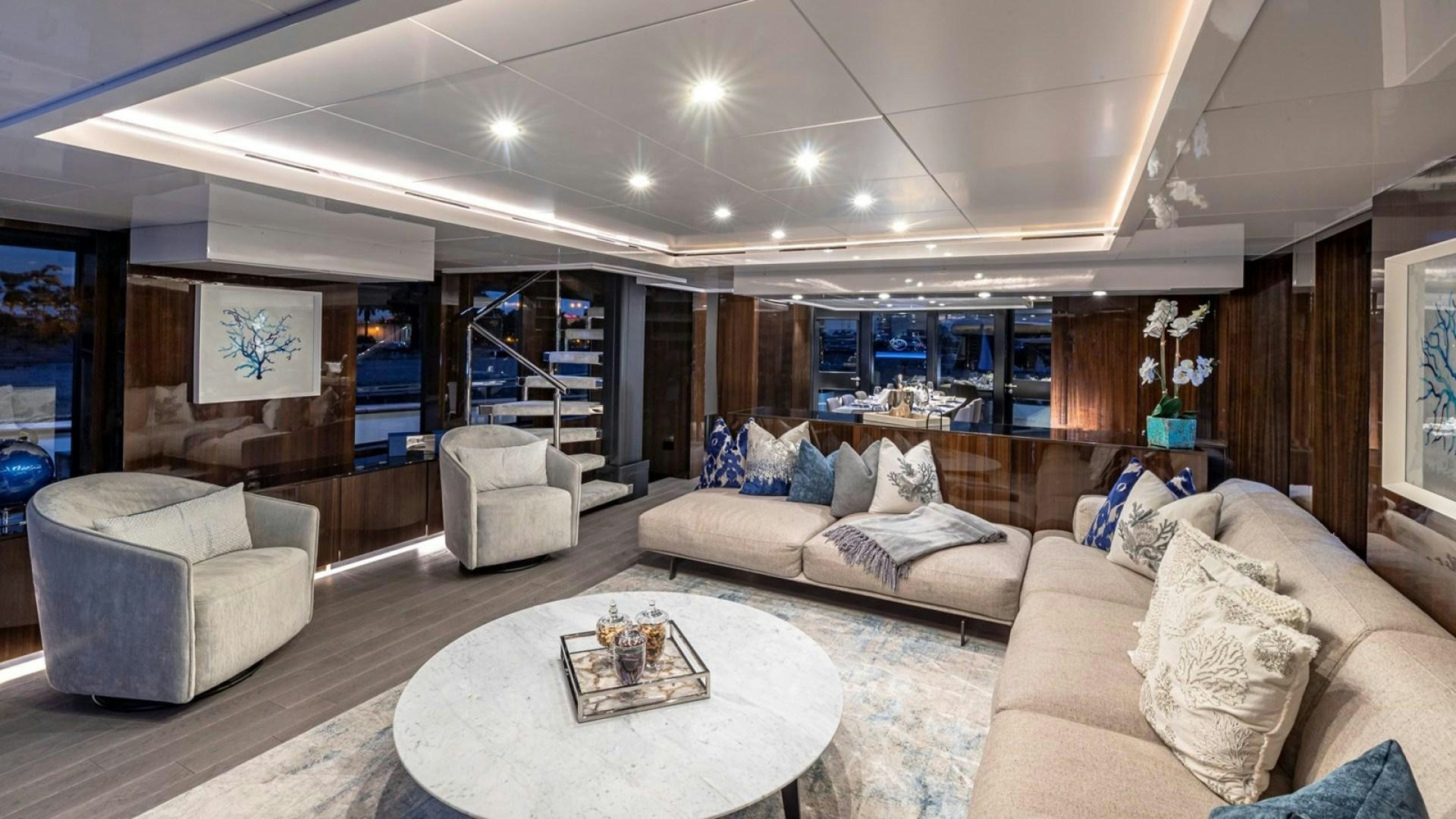 a living room with a large window aboard OCULUS Yacht for Sale
