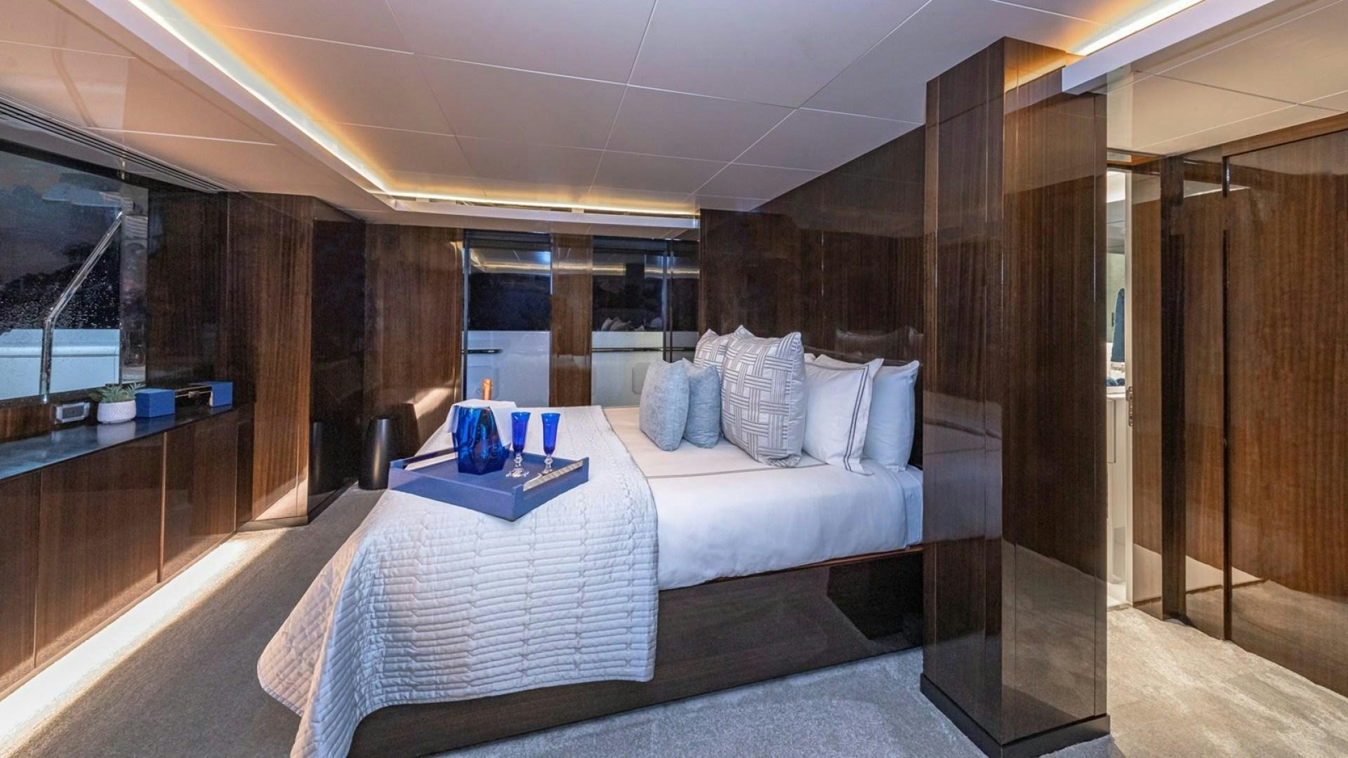 a room with a bed and a table aboard OCULUS Yacht for Sale