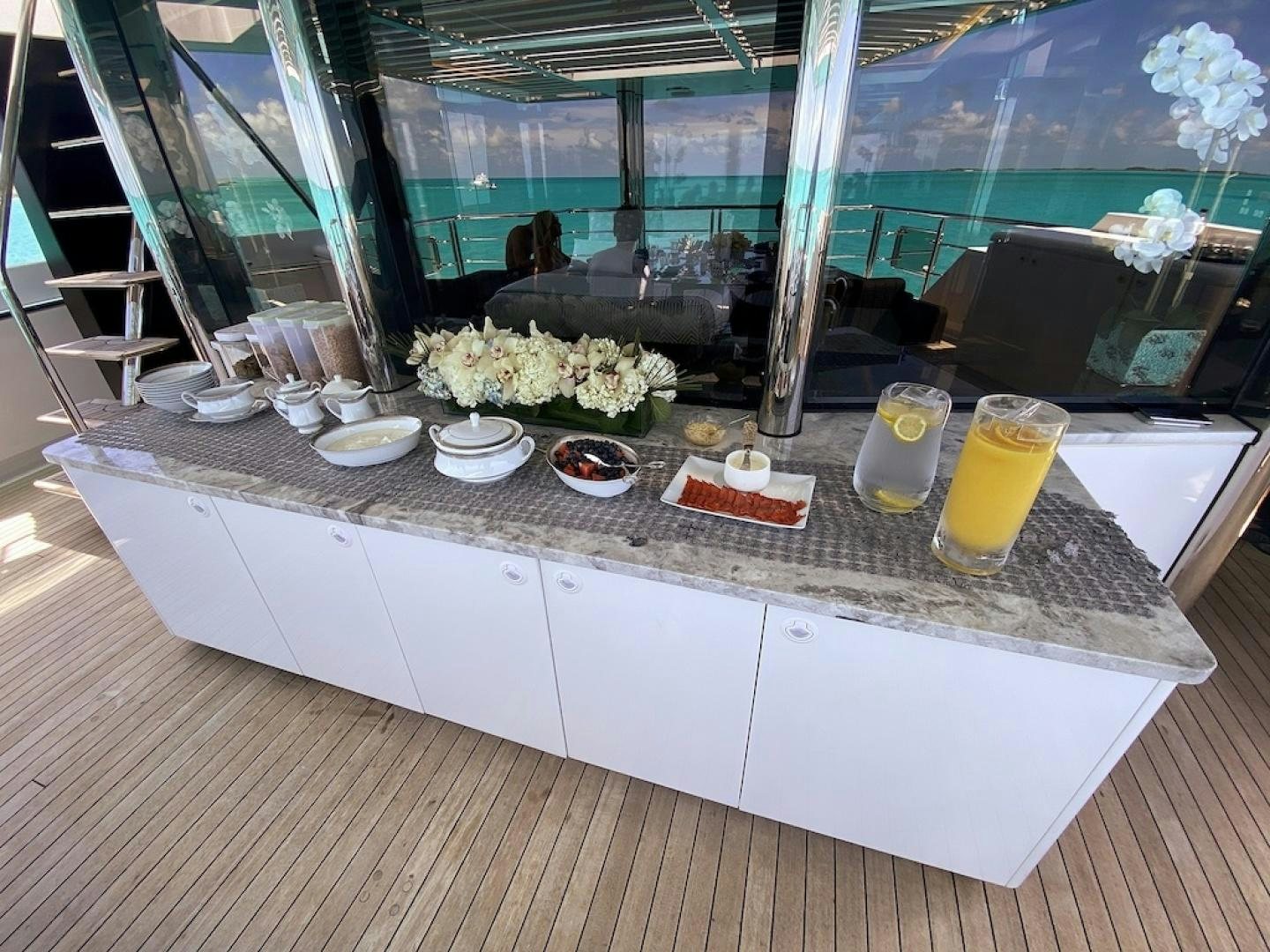 a table with food and drinks aboard OCULUS Yacht for Sale