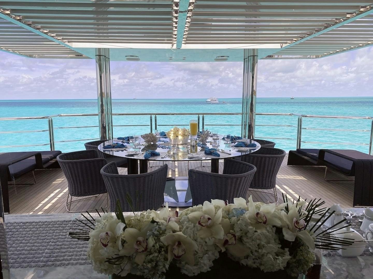 a table set for a dinner aboard OCULUS Yacht for Sale
