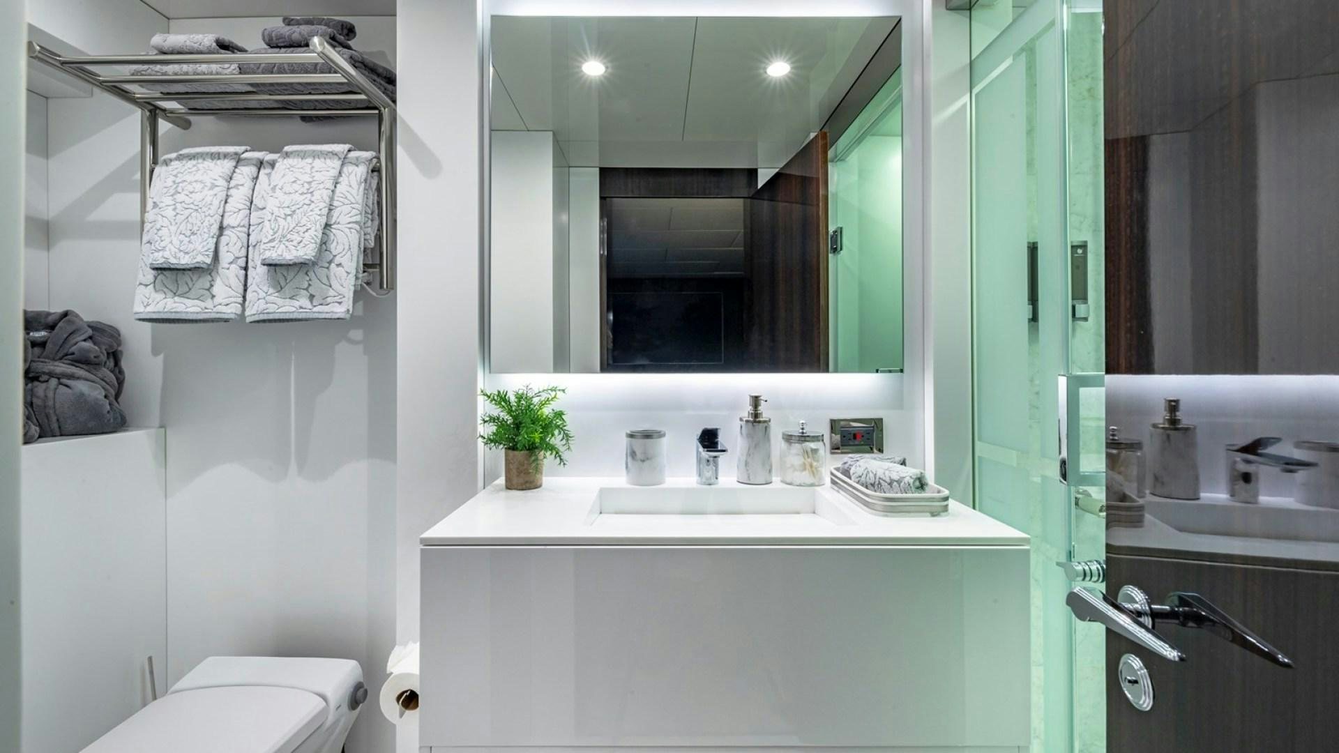 a bathroom with a mirror and towels aboard OCULUS Yacht for Sale