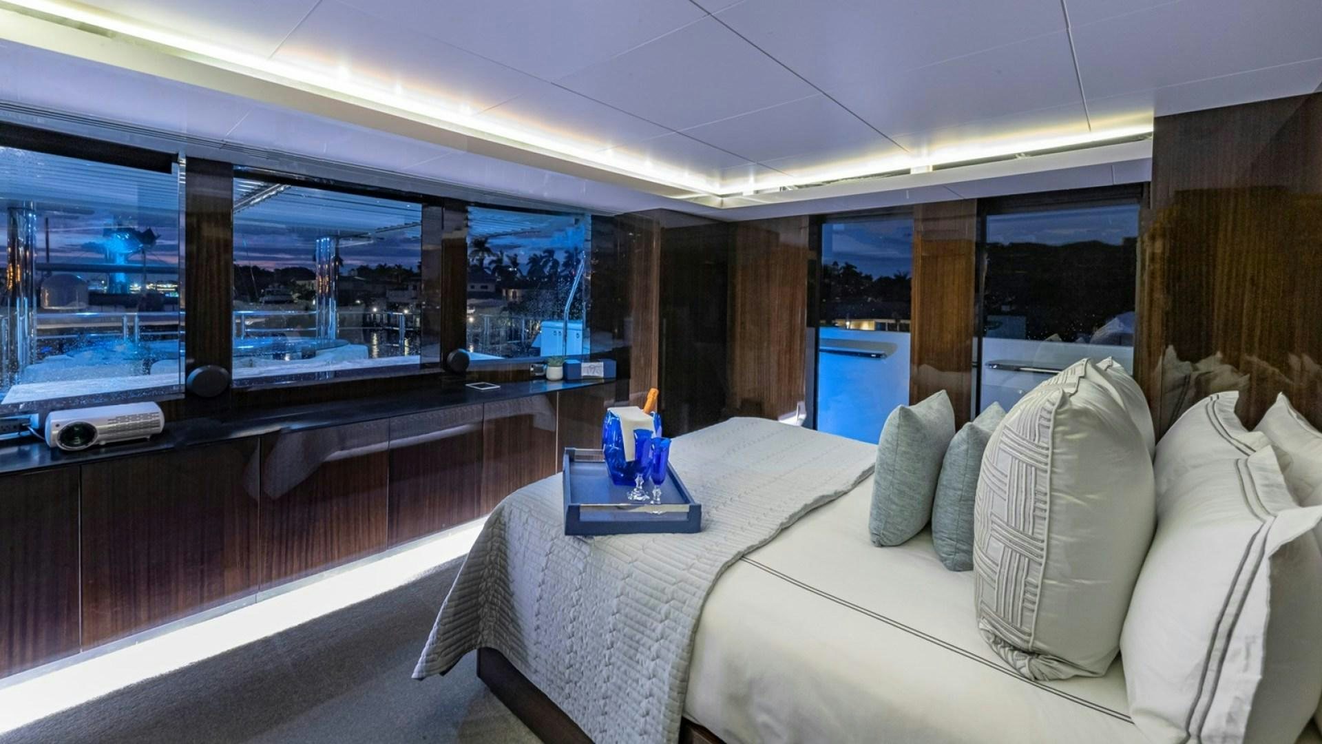 a room with a bed and a window aboard OCULUS Yacht for Sale