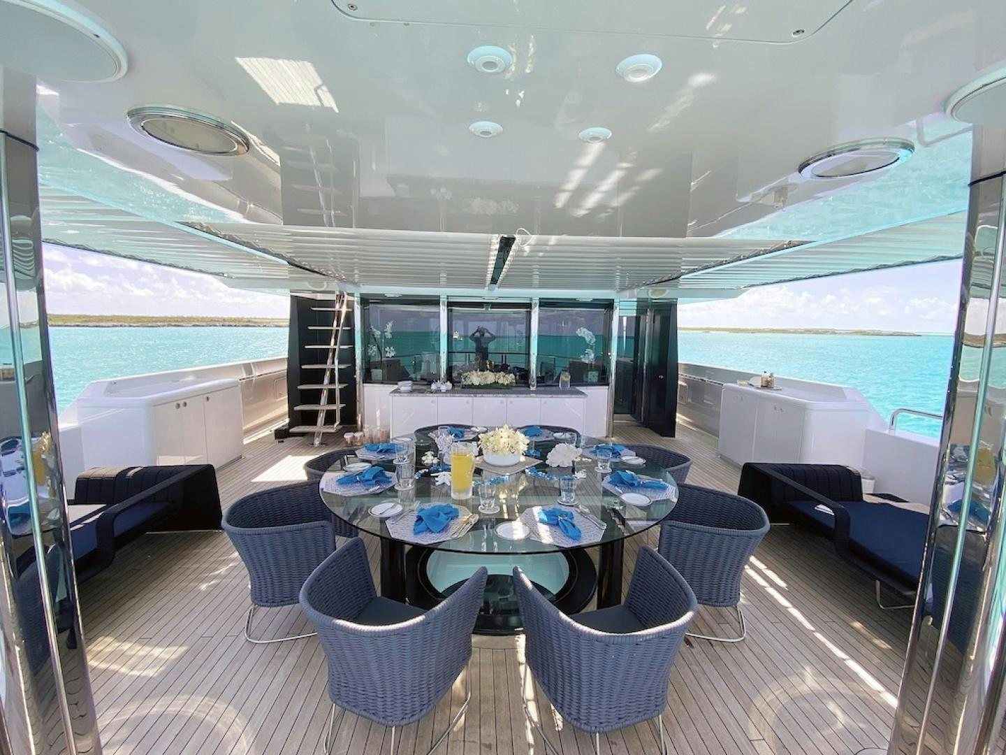 a large lounge area with a table and chairs aboard OCULUS Yacht for Sale