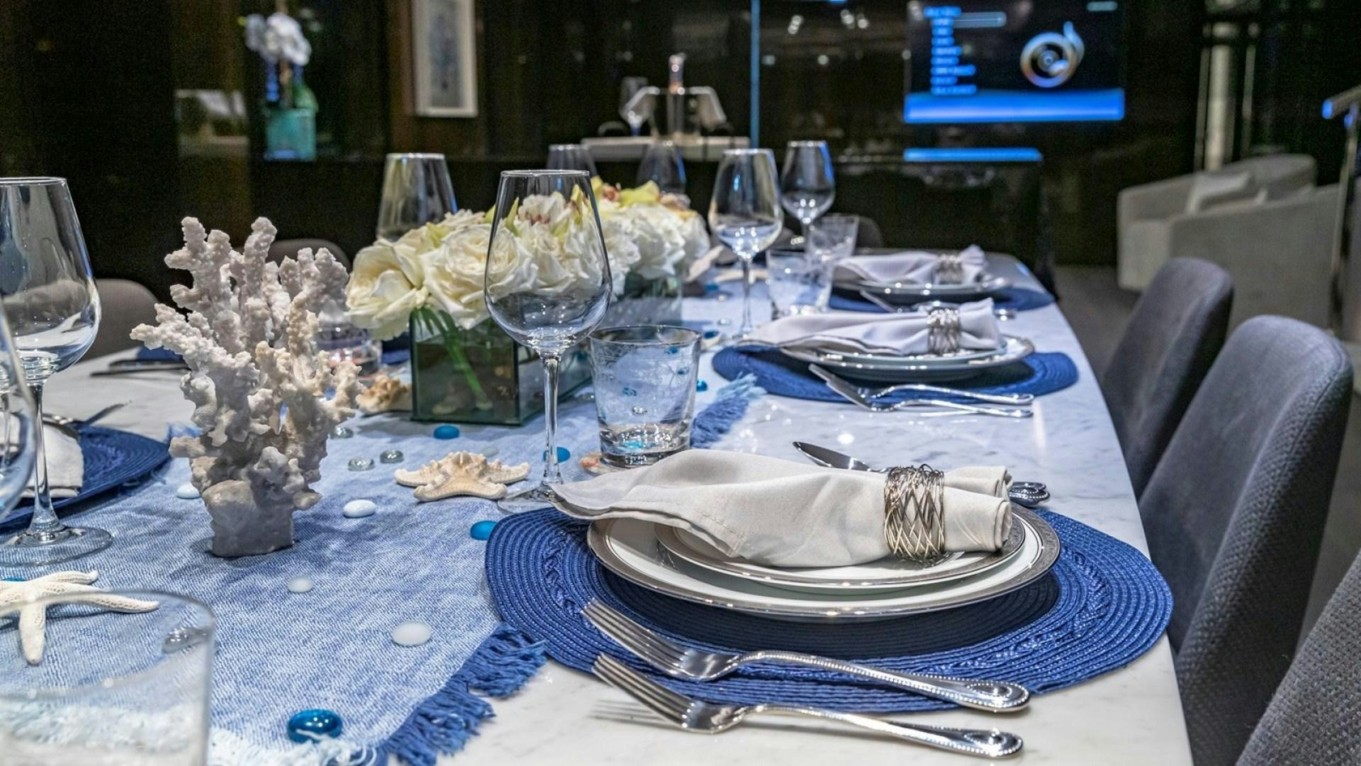 a table set with place settings aboard OCULUS Yacht for Sale