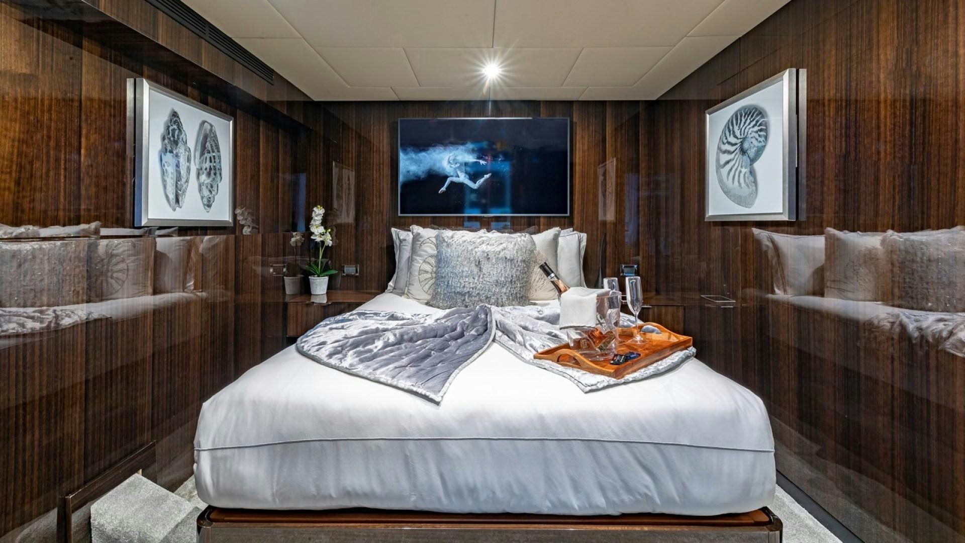 a room with a bed and a couch aboard OCULUS Yacht for Sale