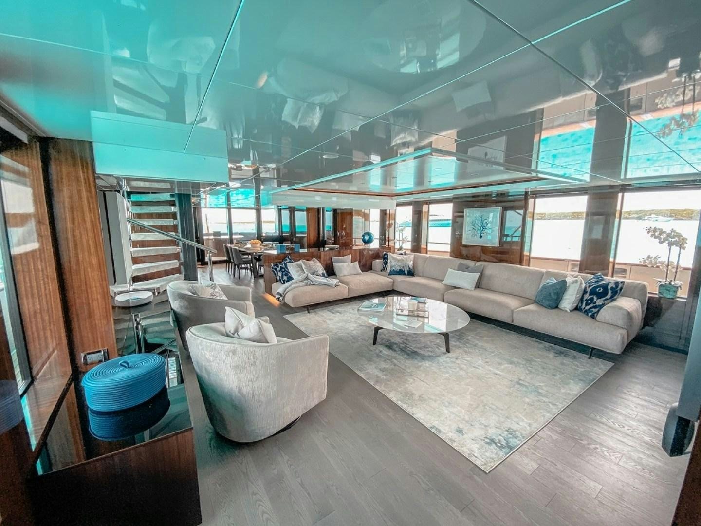 a living room with a large window aboard OCULUS Yacht for Sale