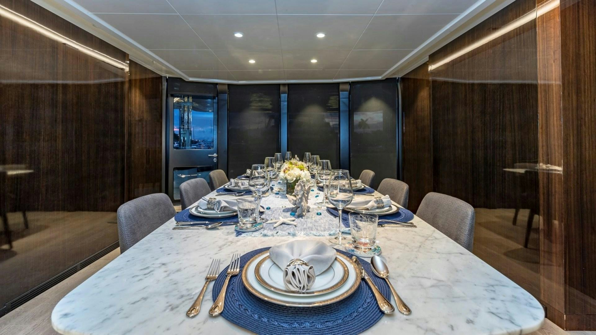 a table set for a dinner aboard OCULUS Yacht for Sale