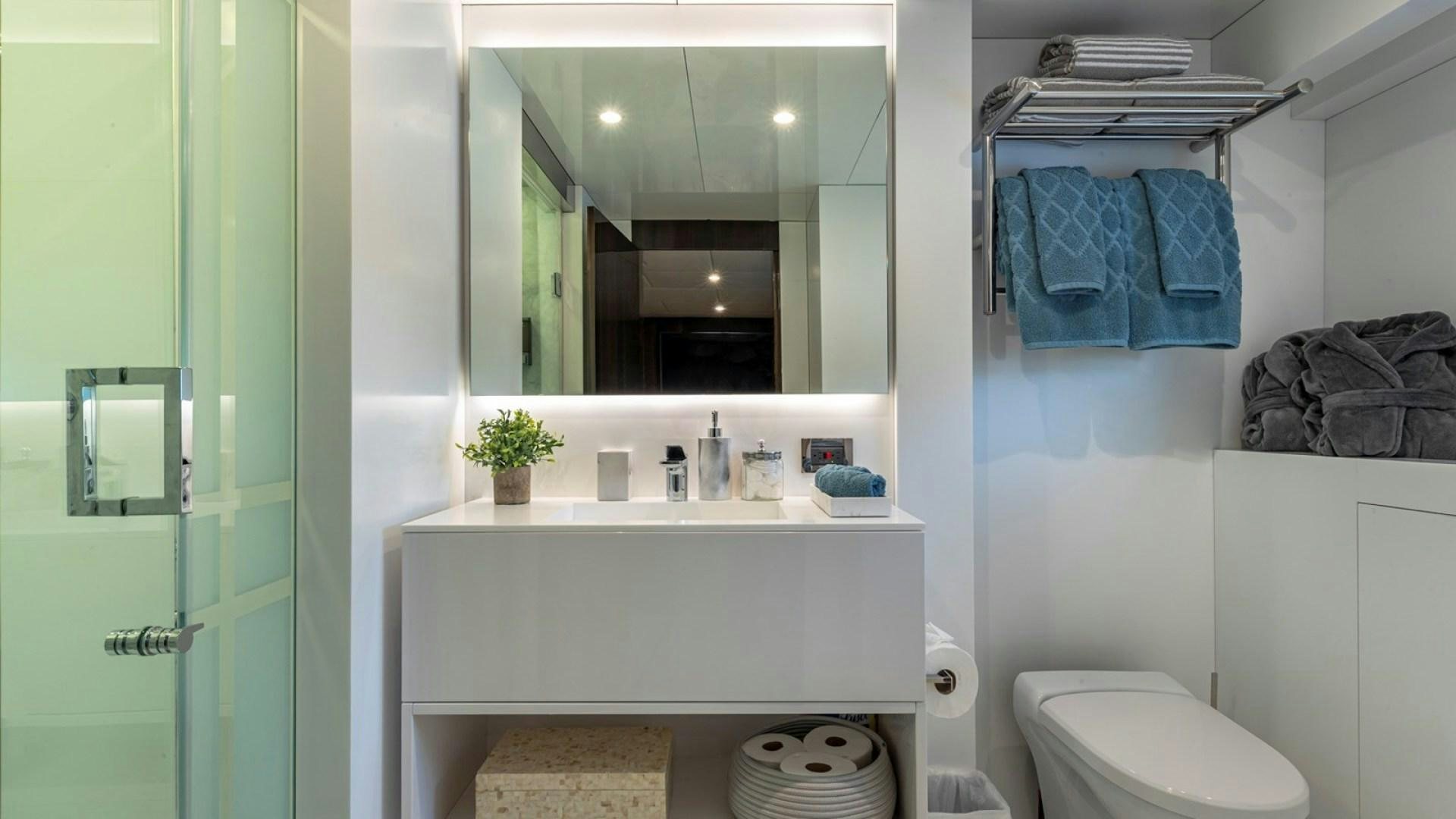 a bathroom with a sink and mirror aboard OCULUS Yacht for Sale