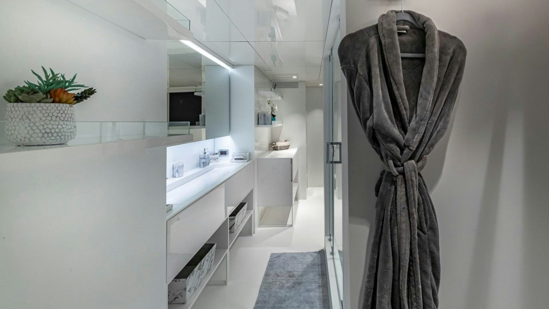 a person's pants on a white wall in a kitchen aboard OCULUS Yacht for Sale