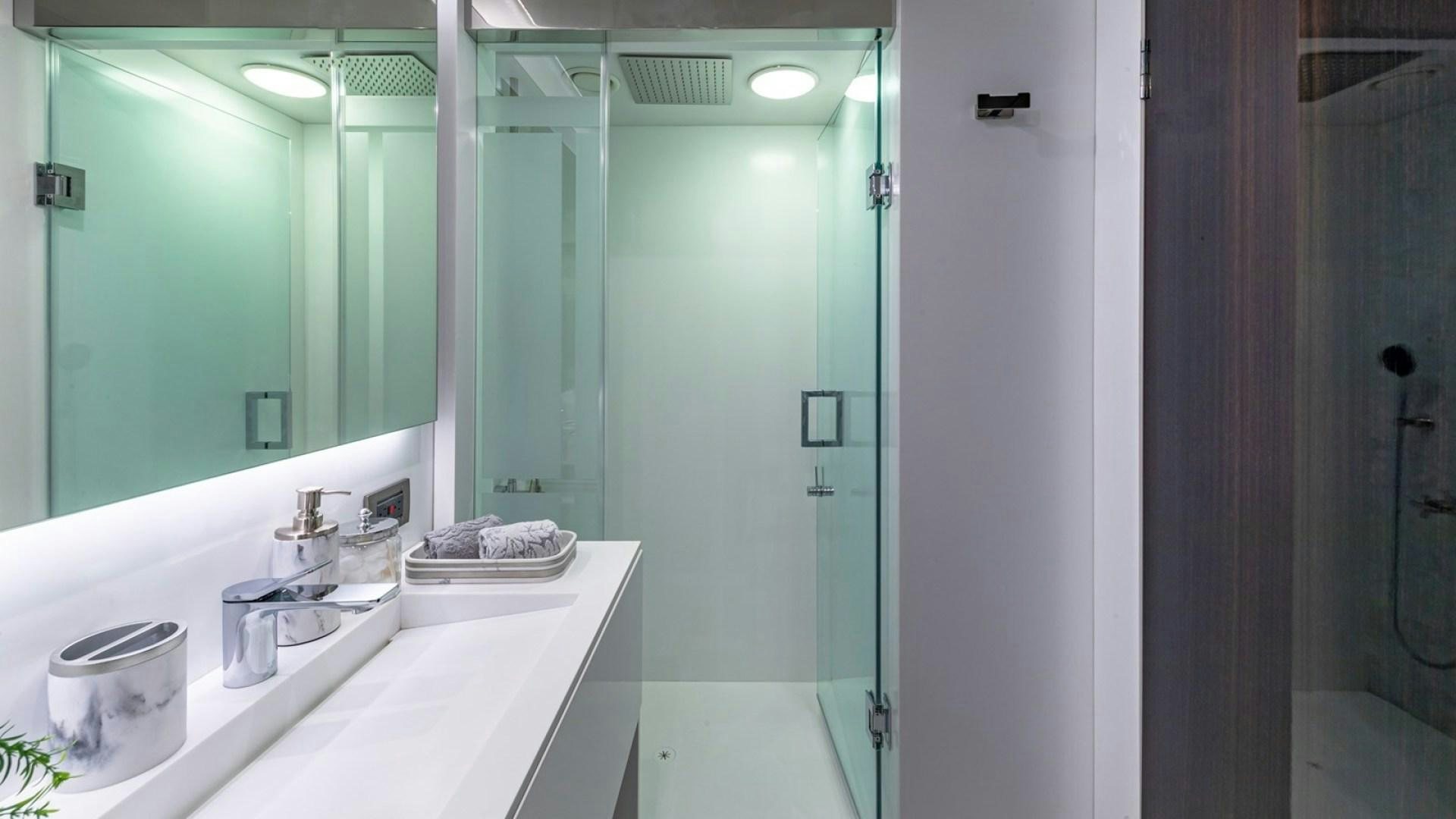 a bathroom with a large mirror aboard OCULUS Yacht for Sale