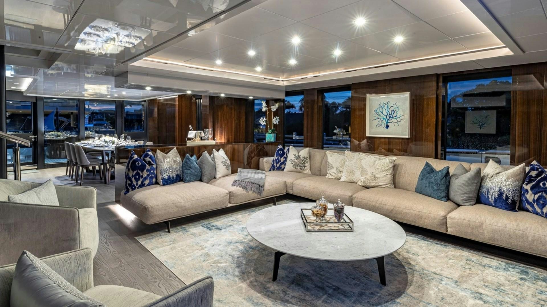 a living room with a couch and a table aboard OCULUS Yacht for Sale