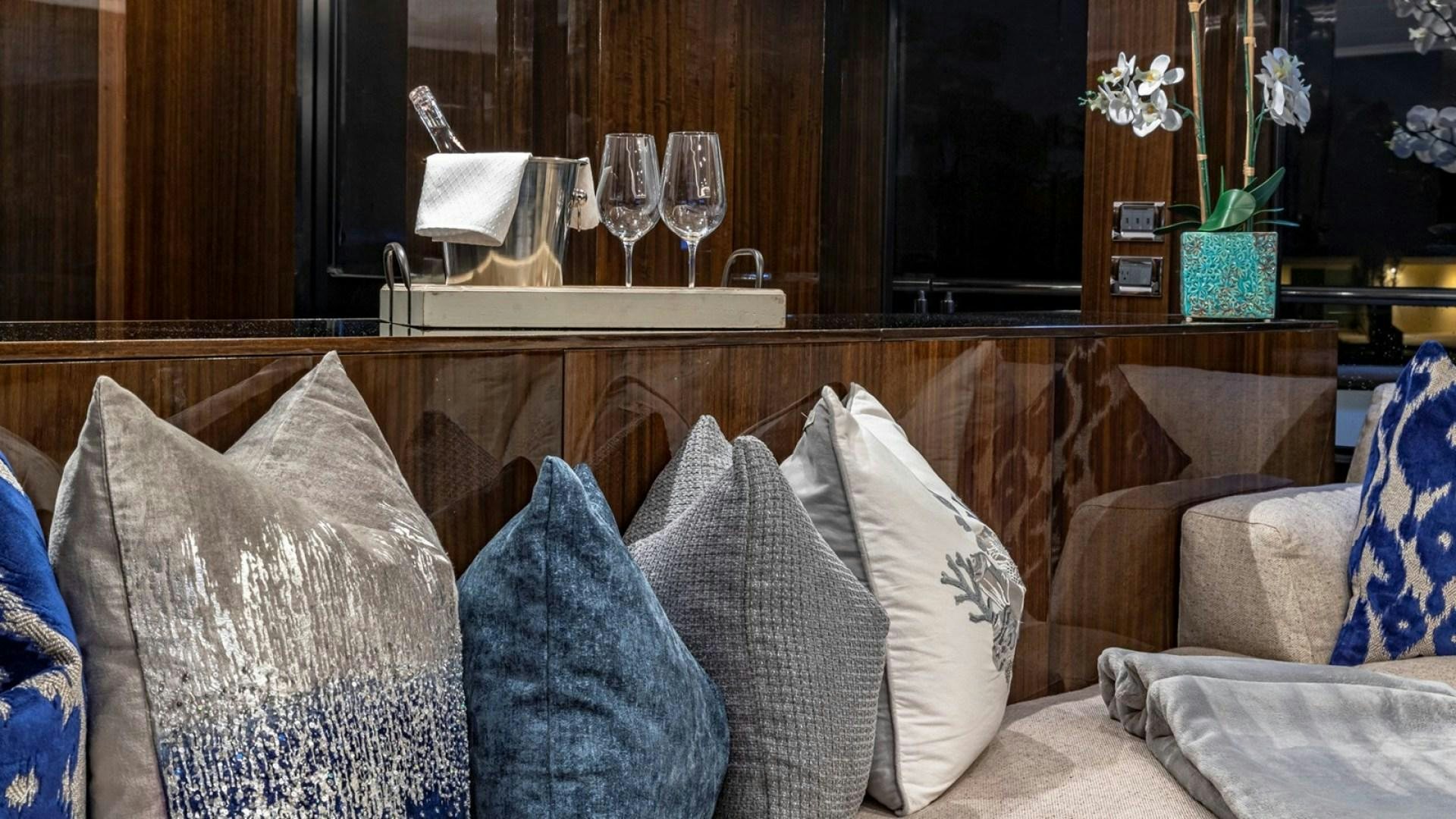 a room with couches and a coffee table aboard OCULUS Yacht for Sale