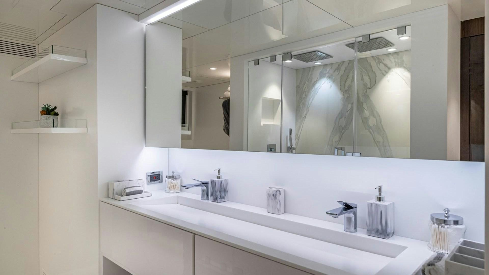 a bathroom with a large mirror aboard OCULUS Yacht for Sale