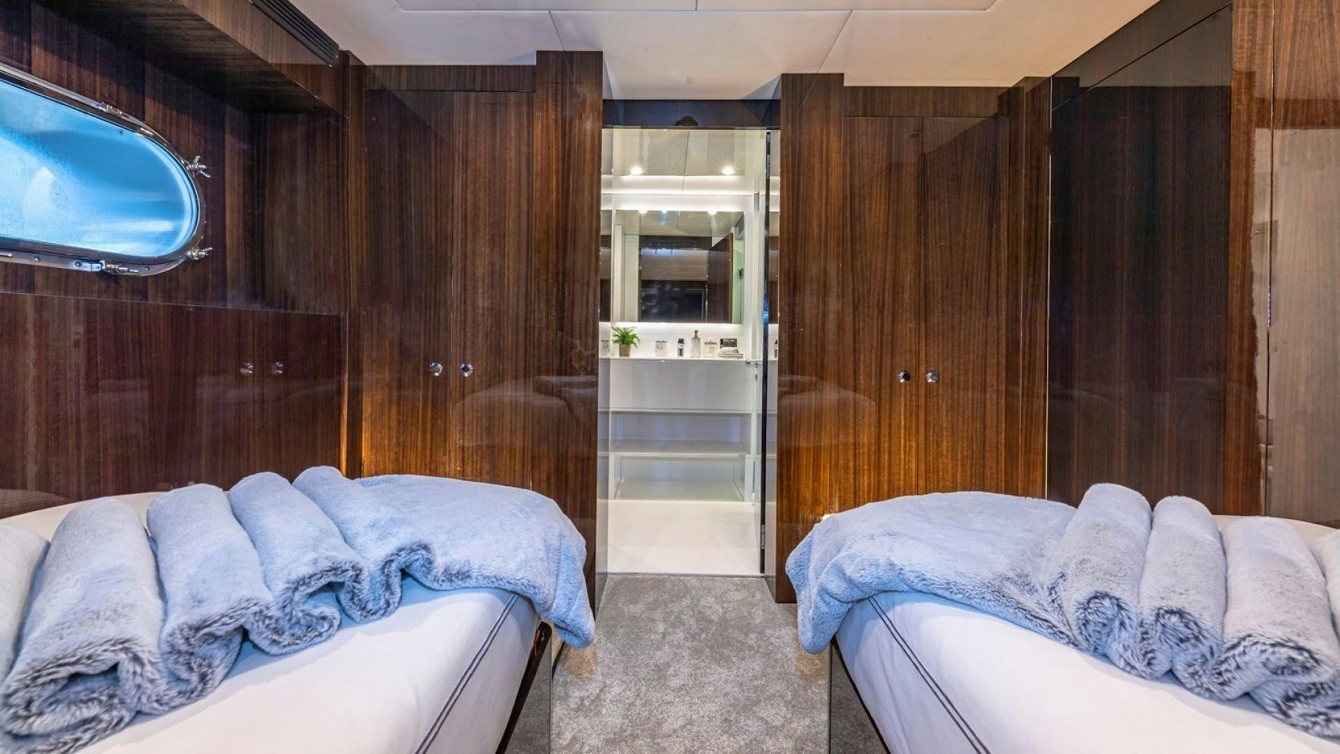 a room with two beds aboard OCULUS Yacht for Sale