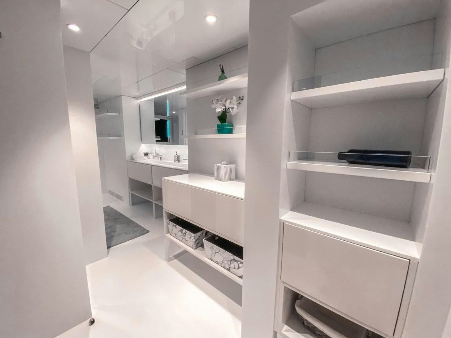 a white room with white cabinets aboard OCULUS Yacht for Sale